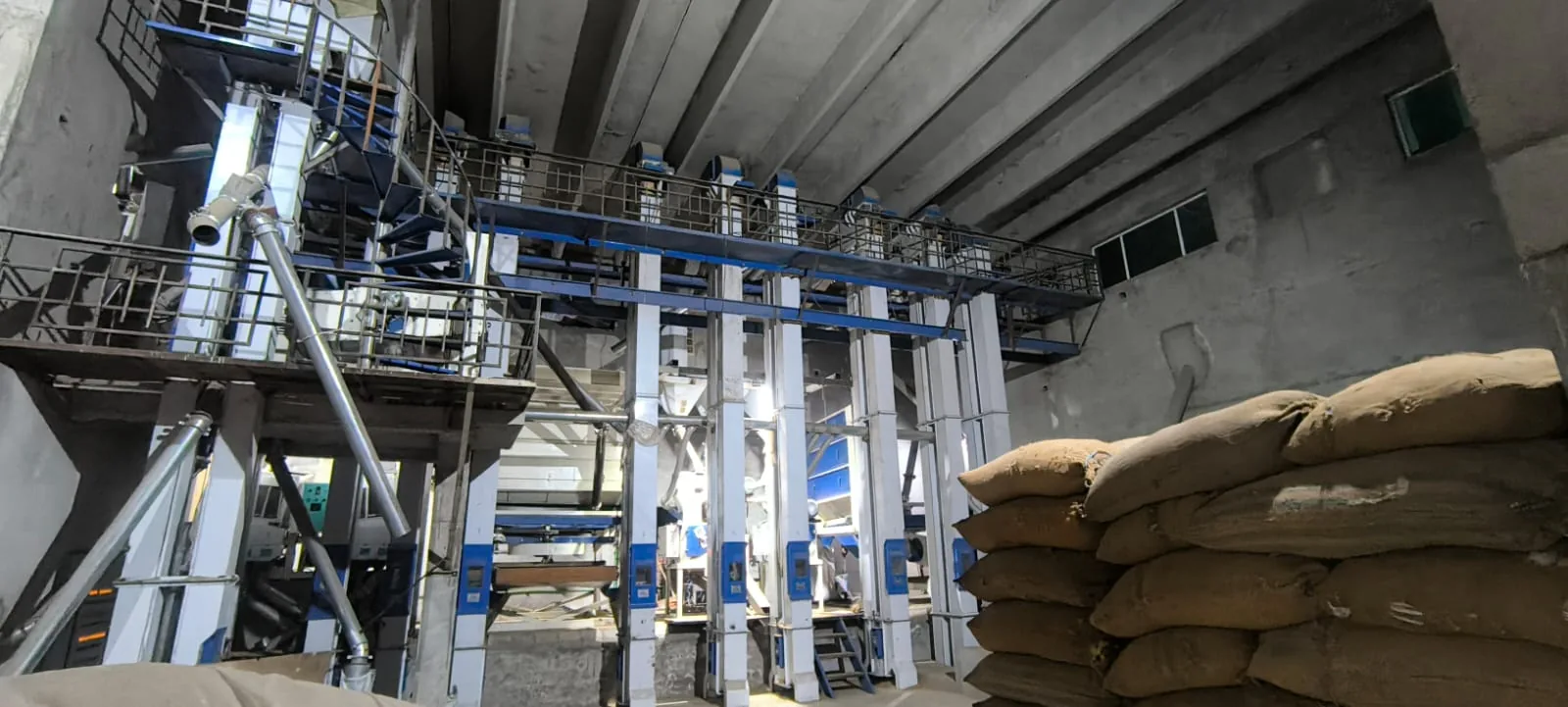 Conveyors, platforms and processing equipment inside a rice mill
