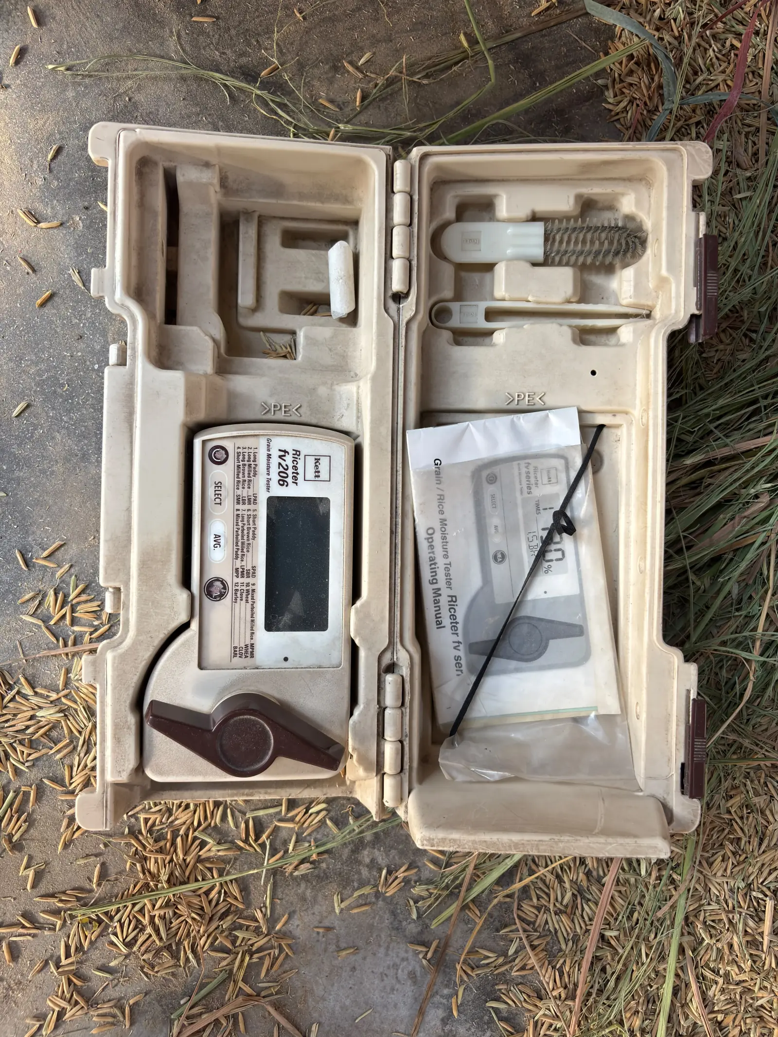 A portable grain moisture tester in its case; no measured reading is displayed